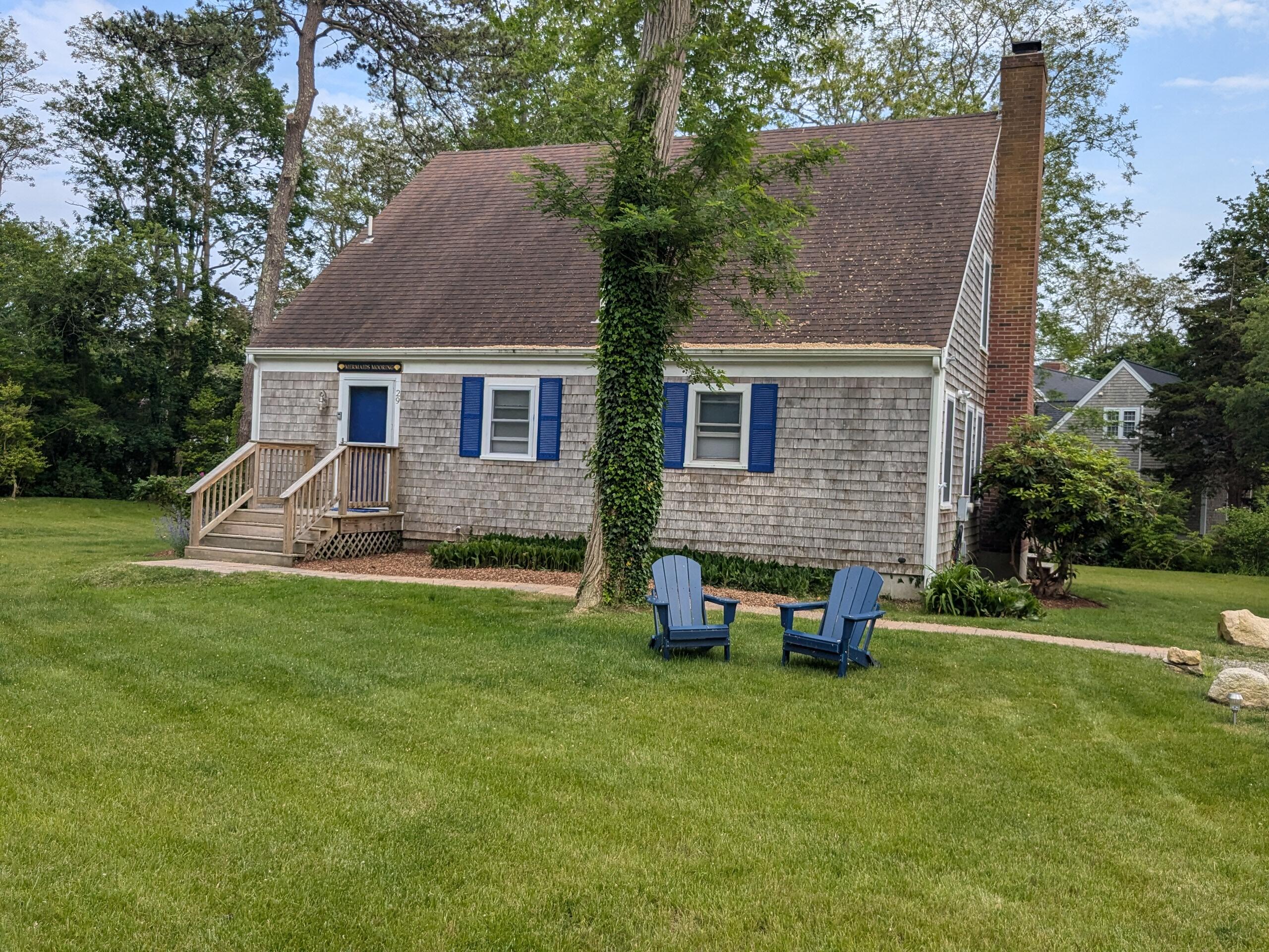 29 Pilgrim Road Dennis, MA 02638 - Photo 6 of 54 a backyard of a house with table and chairs