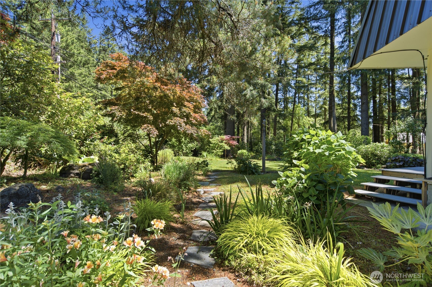 3050 Southeast Mullenix Road Port Orchard, WA 98367 - Photo 31 of 40 a backyard of a house with a garden