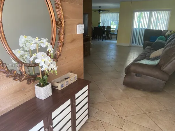 a dining room with furniture and flowers