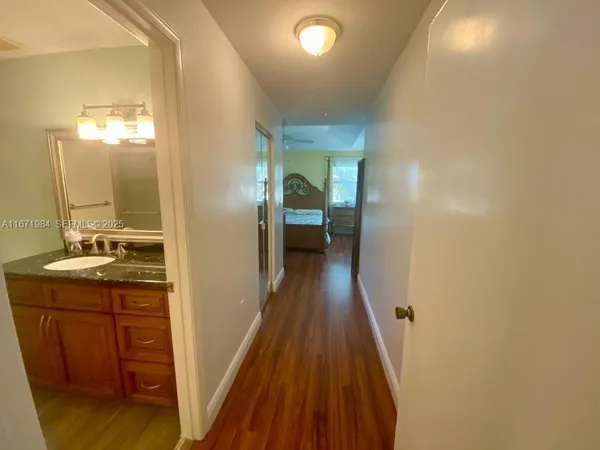 a bedroom with a bed and a mirror on the dresser