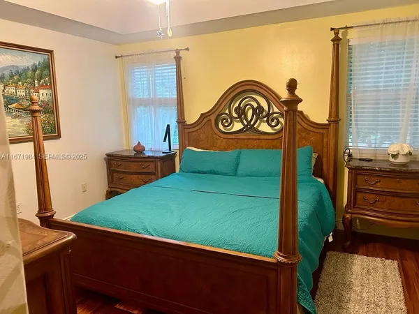 a living room with furniture and a painting on the wall