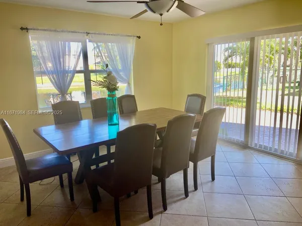 a view of a dining room with furniture and window
