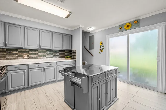 a kitchen with stainless steel appliances granite countertop a stove a sink and a refrigerator
