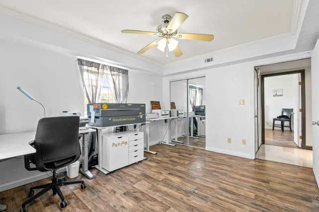 a kitchen with a table chairs refrigerator and cabinets