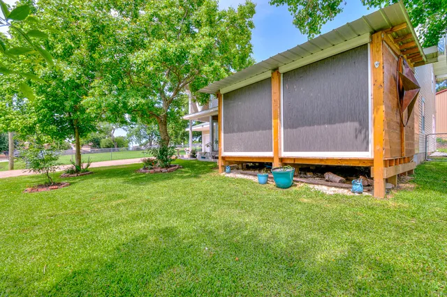 a view of backyard with large tree