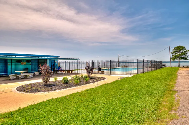 a view of a house with swimming pool and sitting area