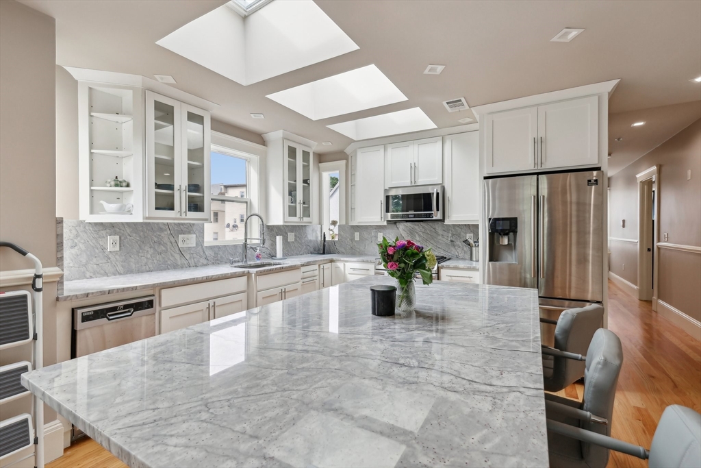 51 Hamilton Street, Unit 3 Boston, MA 02125 - Photo 12 of 21 a kitchen with sink cabinets and refrigerator