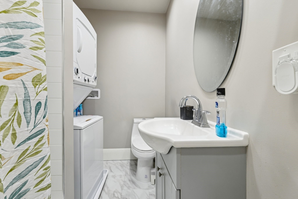 51 Hamilton Street, Unit 3 Boston, MA 02125 - Photo 13 of 21 a bathroom with a sink a toilet and a mirror