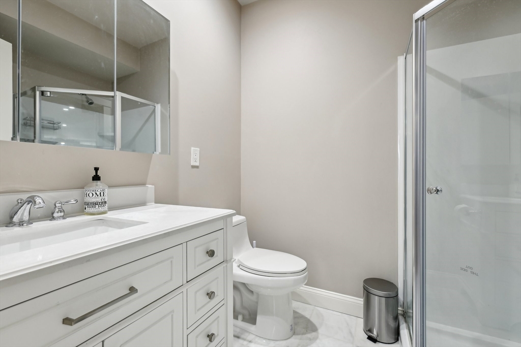 51 Hamilton Street, Unit 3 Boston, MA 02125 - Photo 17 of 21 a bathroom with a granite countertop sink mirror vanity and toilet