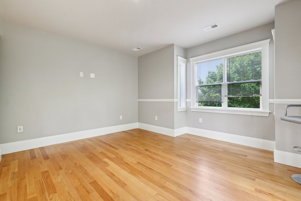 51 Hamilton Street, Unit 3 Boston, MA 02125 - Photo 18 of 21 a view of an empty room with wooden floor and a window