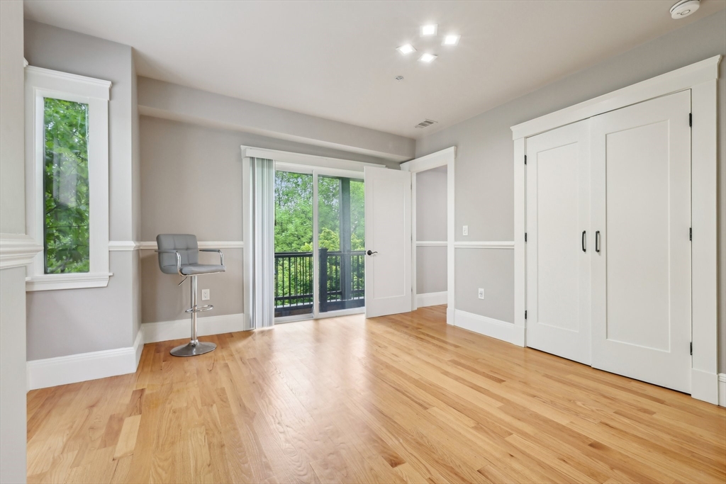 51 Hamilton Street, Unit 3 Boston, MA 02125 - Photo 20 of 21 a view of empty room with wooden floor and fan