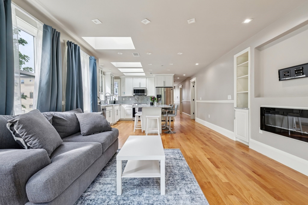 51 Hamilton Street, Unit 3 Boston, MA 02125 - Photo 4 of 21 a living room with furniture wooden floor and a fireplace