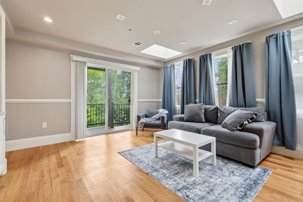51 Hamilton Street, Unit 3 Boston, MA 02125 - Photo 6 of 21 a living room with furniture and a large window