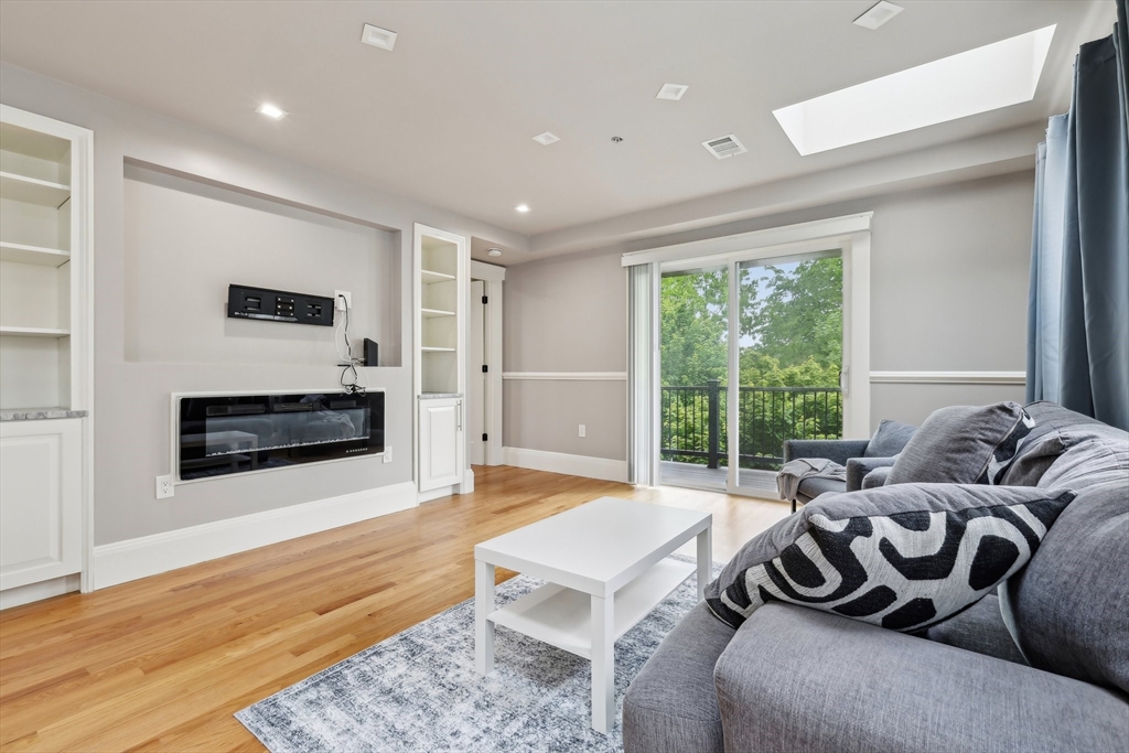 51 Hamilton Street, Unit 3 Boston, MA 02125 - Photo 7 of 21 a bedroom with furniture and a fireplace