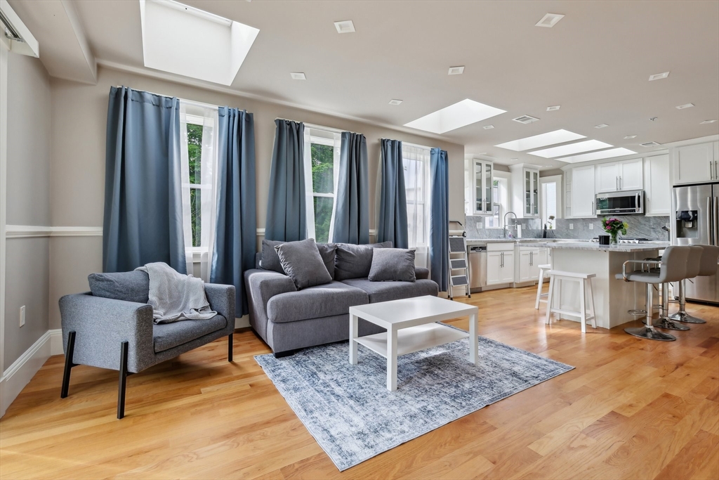 51 Hamilton Street, Unit 3 Boston, MA 02125 - Photo 8 of 21 a living room with furniture and a rug