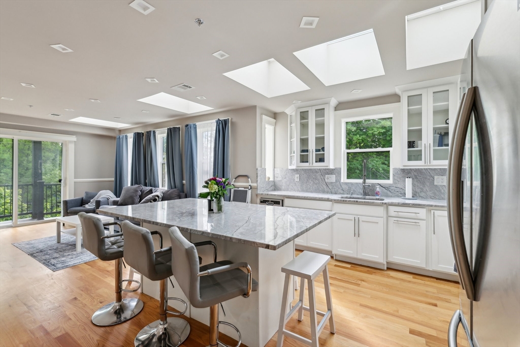 51 Hamilton Street, Unit 3 Boston, MA 02125 - Photo 10 of 21 a dining hall with stainless steel appliances granite countertop a dining table chairs and granite counter tops