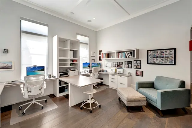 a work room with furniture wooden floor and windows