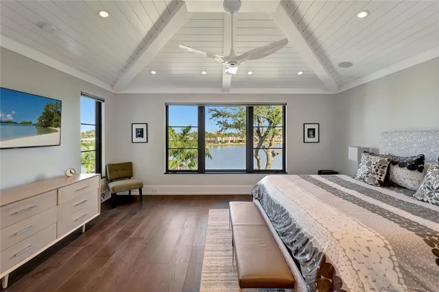 a bedroom with bed and a large window