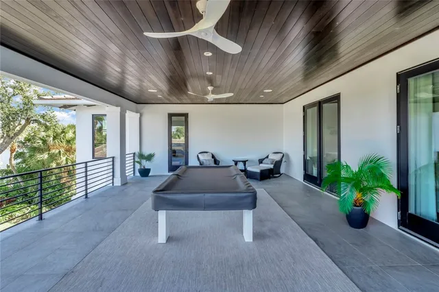 a living room with furniture flowerpot and wooden floor