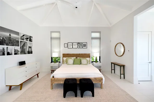 a bedroom with furniture and a large mirror