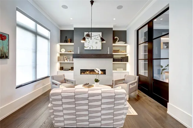 a living room with furniture fireplace and wooden floor