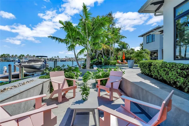 an aerial view of a house with garden space and trees all around