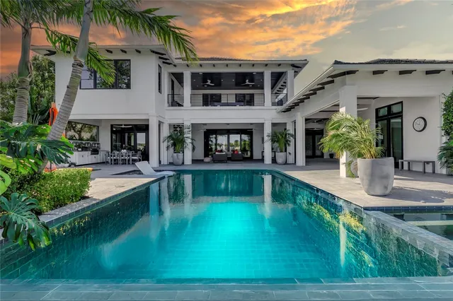 an aerial view of a houses with a lake view
