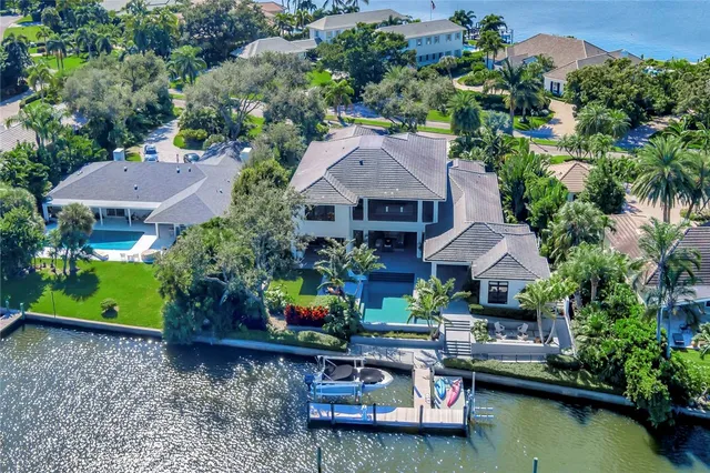 an aerial view of a house with a garden and lake view
