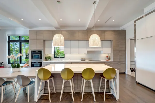 a kitchen with a dining table and chairs