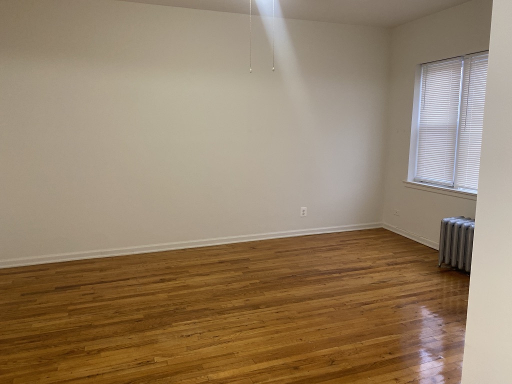 3045 West 63rd Street, Unit 201 Chicago, IL 60629 - Photo 6 of 8 a view of an empty room and wooden floor