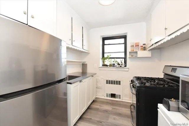 a kitchen with a refrigerator and a stove