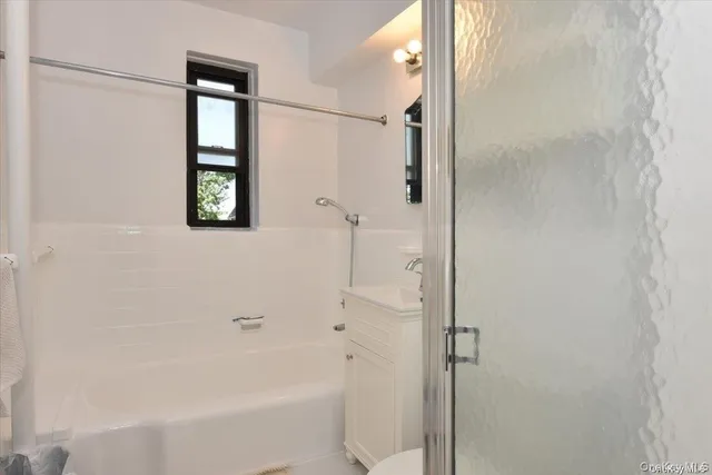 a bathroom with a bathtub and shower