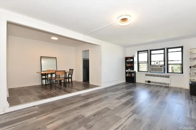 an empty room with furniture and a large window