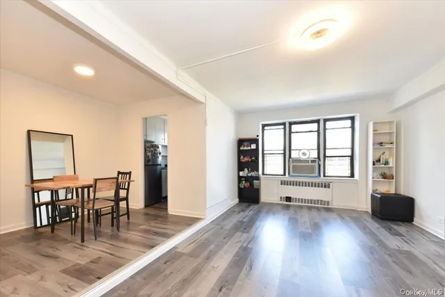 a view of a living room and dining room with wooden floor