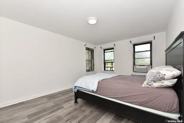 a bedroom with a bed and window