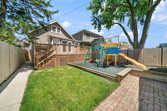 a view of a house with swimming pool next to a yard