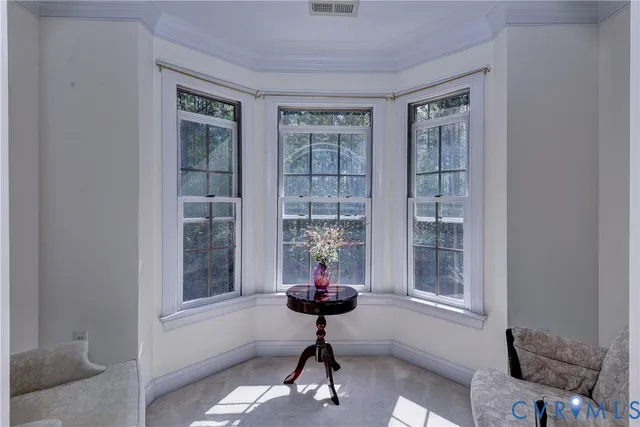 a spacious bedroom with a bed and a chandelier