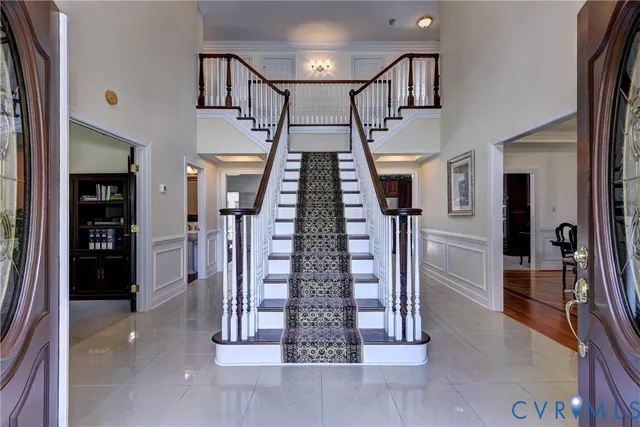 a living room with furniture and a book shelf
