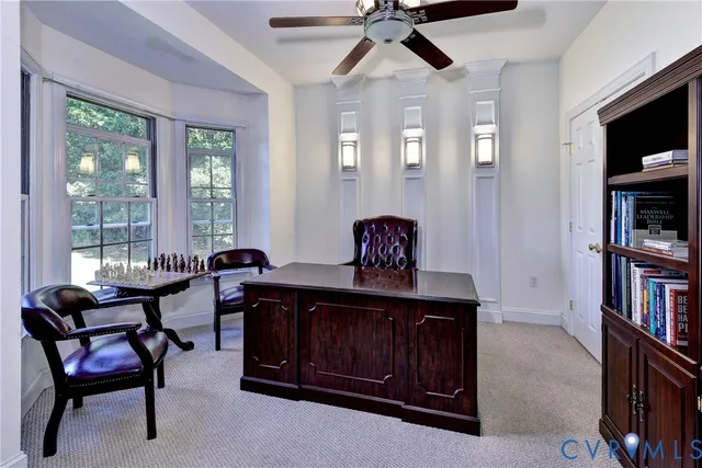 a living room with furniture and floor to ceiling windows