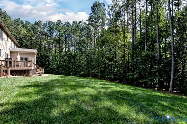 a view of a porch with furniture and a yard