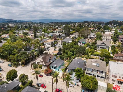 a aerial view of multi story residential apartment building with yard