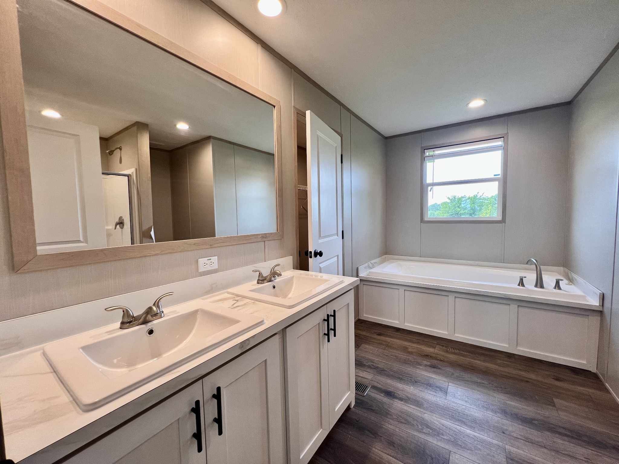 1037 McAfee Road Morrison, TN 37357 - Photo 12 of 23 a bathroom with a double vanity sink mirror double and bathtub