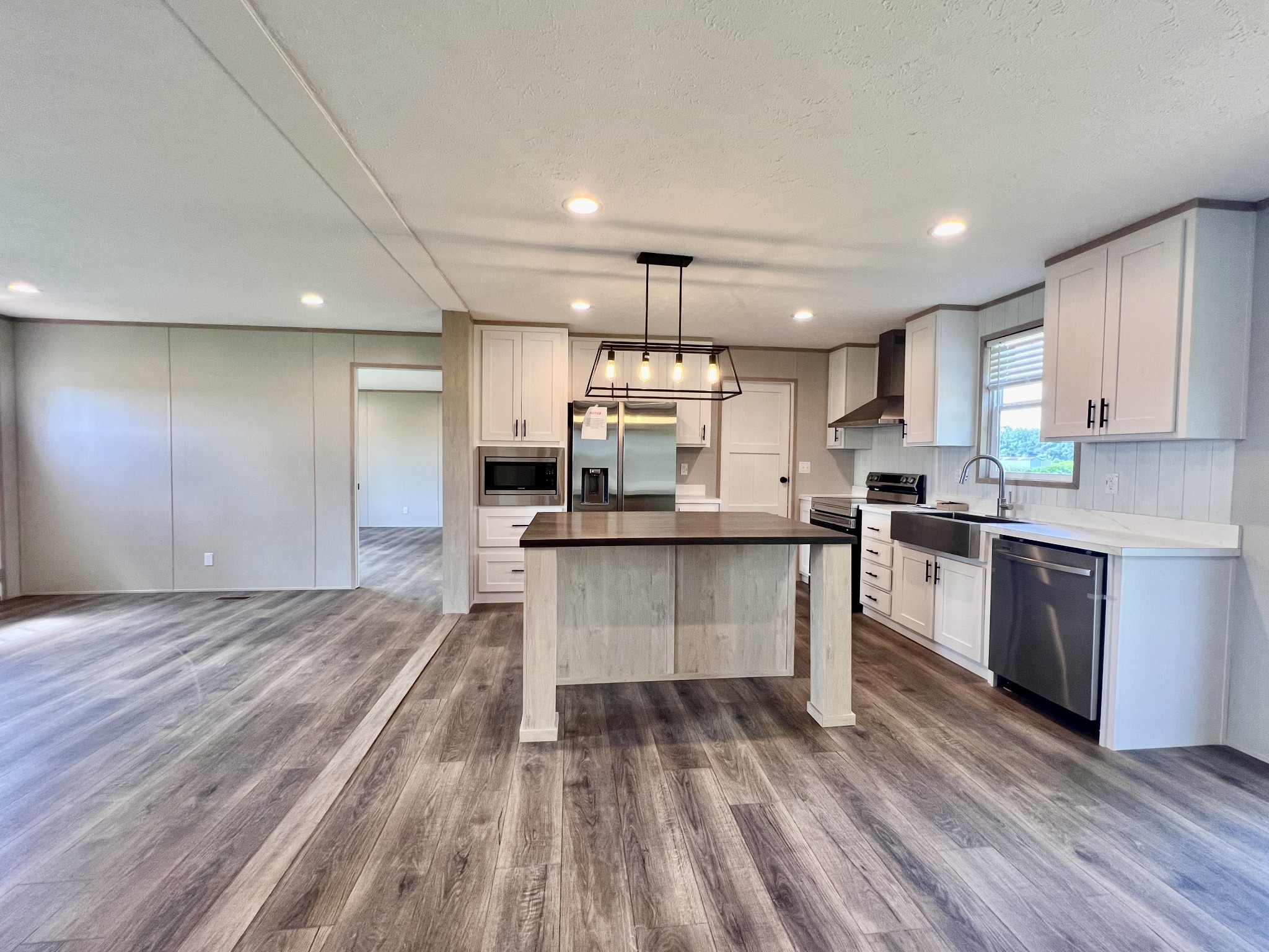 1037 McAfee Road Morrison, TN 37357 - Photo 7 of 23 a kitchen with kitchen island granite countertop wooden floors stainless steel appliances a sink and cabinets