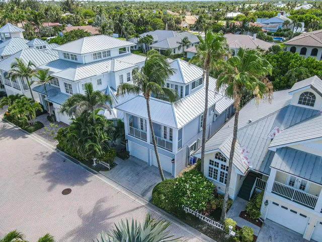 an aerial view of multiple houses with a yard