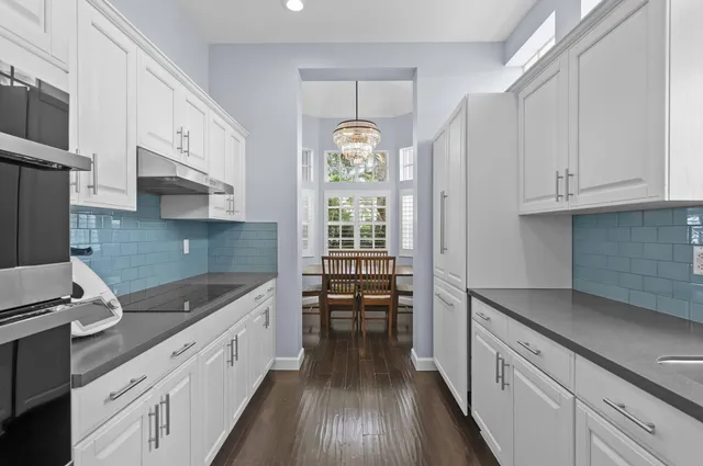 a kitchen with granite countertop a sink stainless steel appliances and cabinets