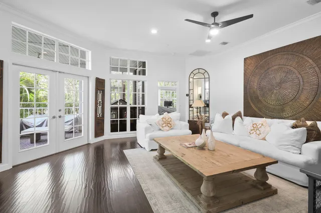a living room with furniture and wooden floor