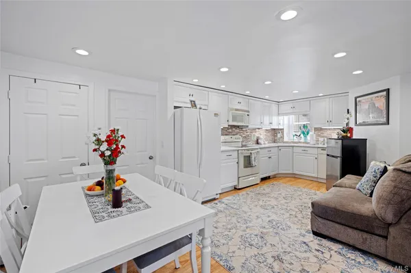 a living room with kitchen island furniture and a kitchen view