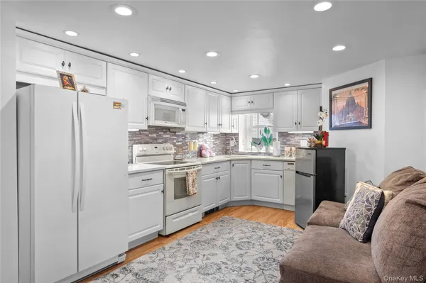a kitchen with stainless steel appliances granite countertop a refrigerator sink and stove