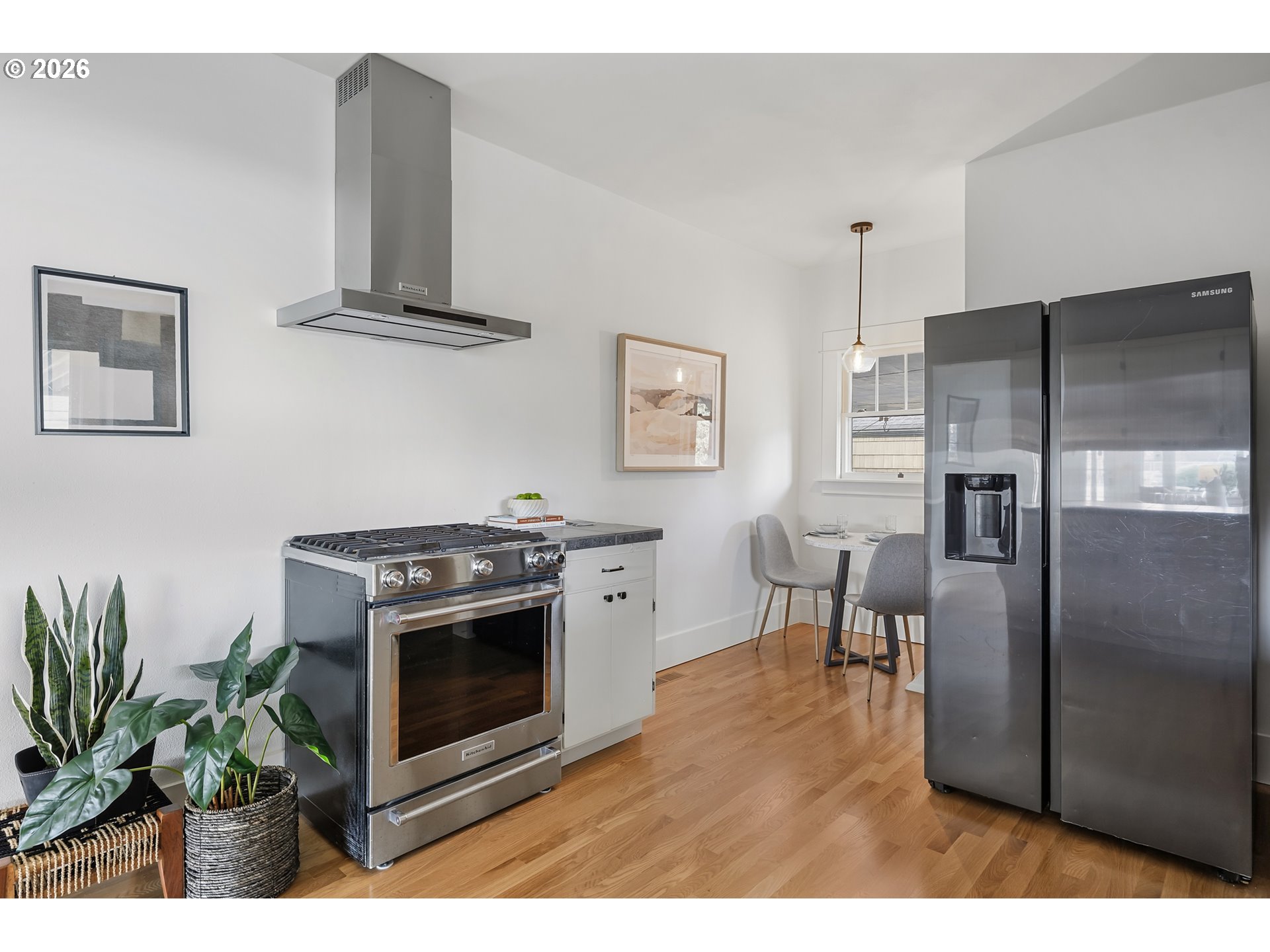 2845 Northeast 53rd Avenue Portland, OR 97213 - Photo 11 of 29 a kitchen with stainless steel appliances a stove a refrigerator a dining table and chairs