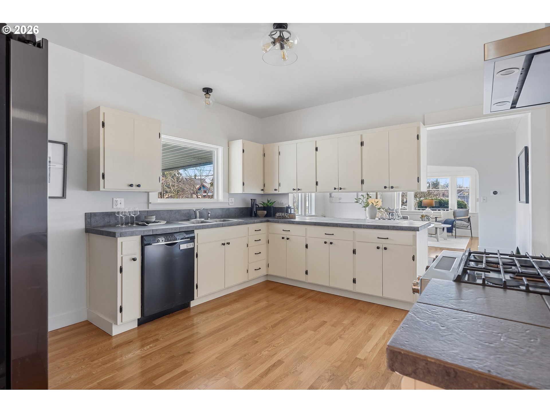 2845 Northeast 53rd Avenue Portland, OR 97213 - Photo 12 of 29 a kitchen with kitchen island granite countertop a sink cabinets and stainless steel appliances